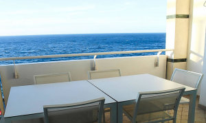 Porch photographed from outside on it with view of ocean in background